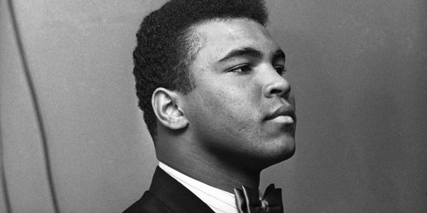 Muhammad Ali, heavyweight champion, buttons his lip as he appears before Illinois Athletic Commission in Chicago, Feb. 25, 1966. Previously, he?d said imminent army induction was unfair - touching off series of events leading to the commission reconsidering its sanction of Clay?s scheduled title defense later this month. (AP Photo)